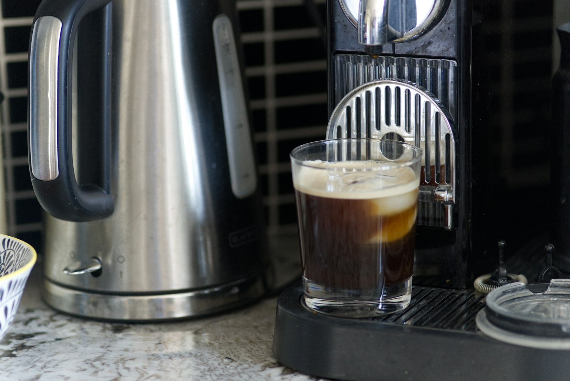 clear glass mug with brown liquid inside